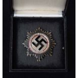 A rare Second World War Nazi German Cross in silver with black enamel Swastika to centre and red