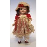 Armand Marseille 'googly eye' doll, mould number 323 4/0, dressed in red costume, with stand, 22cm