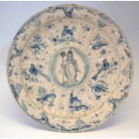 Delft charger, painted with a bishop and initialled 'S.A' the moulded border painted with birds