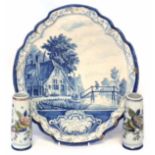 Mukkum Delft plaque, painted in blue with a riverside landscape within moulded border, also a pair