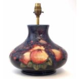 Moorcroft lamp base and shade, decorated with Birds Pecking Fruit pattern on blue ground,