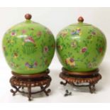 A pair of Chinese Famille Verte jars with covers and stands. No condition reports for this sale