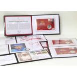 Collection of coins and stamps in six albums. No condition reports for this sale