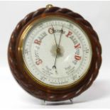 Edwardian oak case circular aneroid barometer, 29cm diamter with rope edge No condition reports