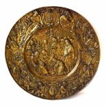 A large circular brass plaque depicting a scene from the Russian Orthodox Church in which the ailing