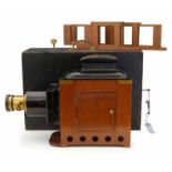 Triumph magic lantern in mahogany, brass and steel plate, fitted for electricity, with two