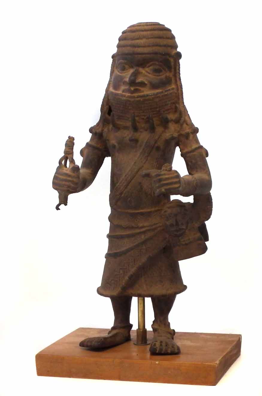 Benin bronze warrior, modelled standing holding the remnants of a spear with mask at his side, 34.