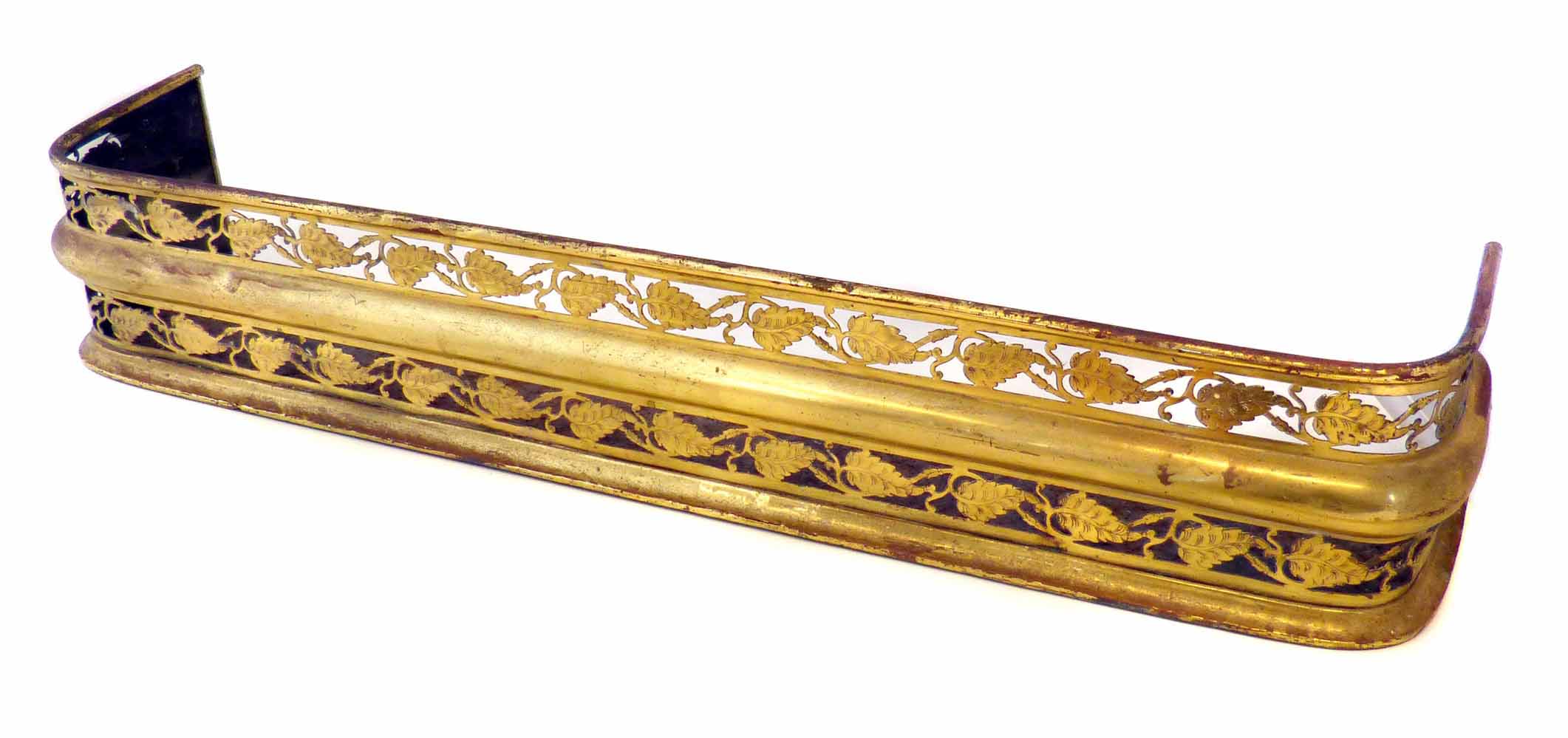 A small Georgian style antique cut brass fireplace fender, with a central band and two tiers of