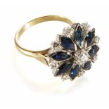 A diamond and sapphire flower head cluster 18ct gold ring central round brilliant cut diamond,