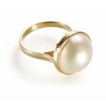 An 18ct gold pearl set ring, the half button shaped pearl approx 13mm diameter. 18ct yellow gold