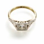 Art Deco diamond solitaire 18ct yellow gold platinum set ring with diamond set shoulders, the