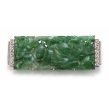 Art Deco carved jadeite and diamond set rectangular panel brooch. The rectangular pierced and carved