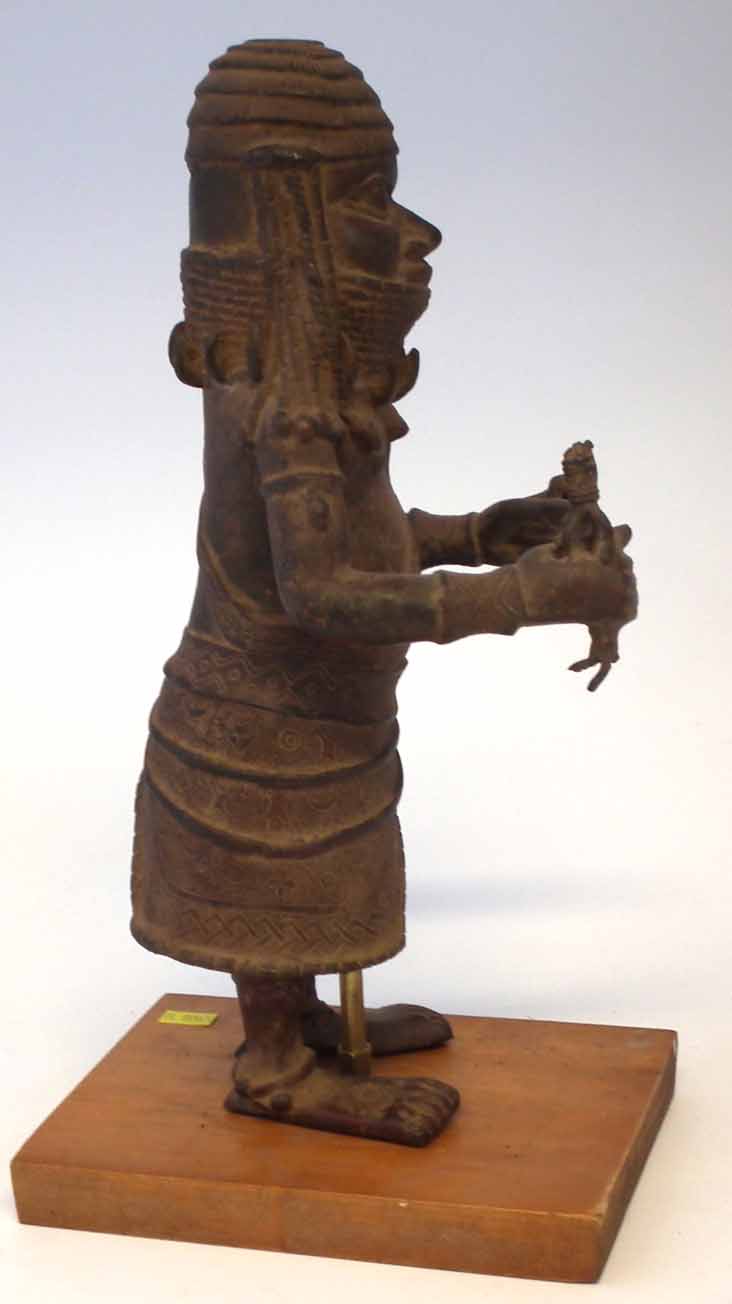 Benin bronze warrior, modelled standing holding the remnants of a spear with mask at his side, 34. - Image 7 of 11