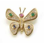 A diamond, emerald, ruby and sapphire set 18ct yellow gold stylized butterfly pendant. Emerald, ruby