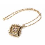 A diamond, emerald and ruby set enamelled offset square canntielle style 18ct gold pendant on a