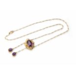 An Edwardian amethyst and seed pearl cluster double drop pendant and chain, the central oval