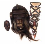 Bete mask, carved wood with filled back, applied animal fur, and hair. Also a small Burkina Faso