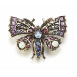 Sapphire, ruby, diamond and opal set silver butterfly brooch, the central oval blue sapphire approx.