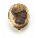 A Georgian small carved oval cameo brooch. The central oval cameo carved in relief with a blackamoor
