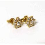 Pair of diamond flower head cluster yellow gold stud earrings, total diamond weight approx. 0.