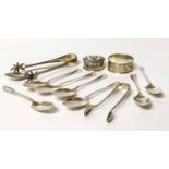 Two pairs of silver tongs, napkin ring, pill box and six tea spoons. No condition reports for this