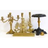 A brass trivet stand, a royal coat of arms candelabra and a pair of candlesticks. No condition