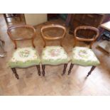 Three Victorian rosewood single chairs with woolwork tapestry seat covers. No condition reports