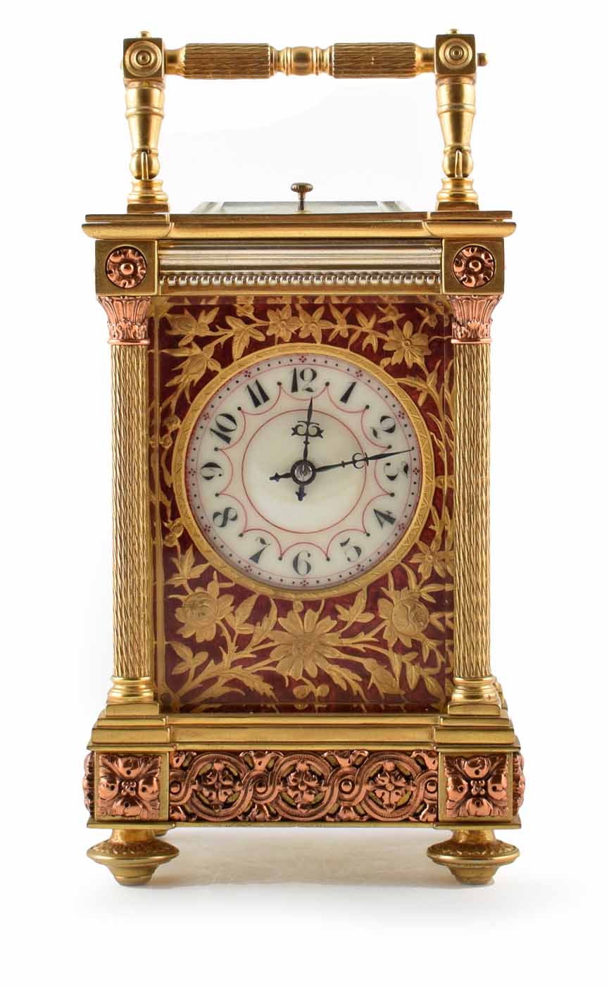 A 19th century carriage clock. Brass case with Corinthian columns and copper metal work framing an