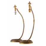 A pair of art noveau style brass table lamps of an acanthus leaf design curving gracefully into a