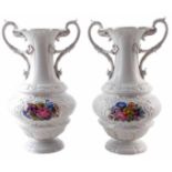 Pair of Meissen twin handled vases, painted with floral sprays between moulded cartouches and