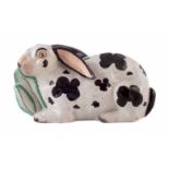 Staffordshire Rabbit, modelled eating lettuce leaves, painted with black patches, mid-19th