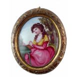 English enamel oval plaque circa 1780 probably Bilston, painted with a lady sat at a table reading