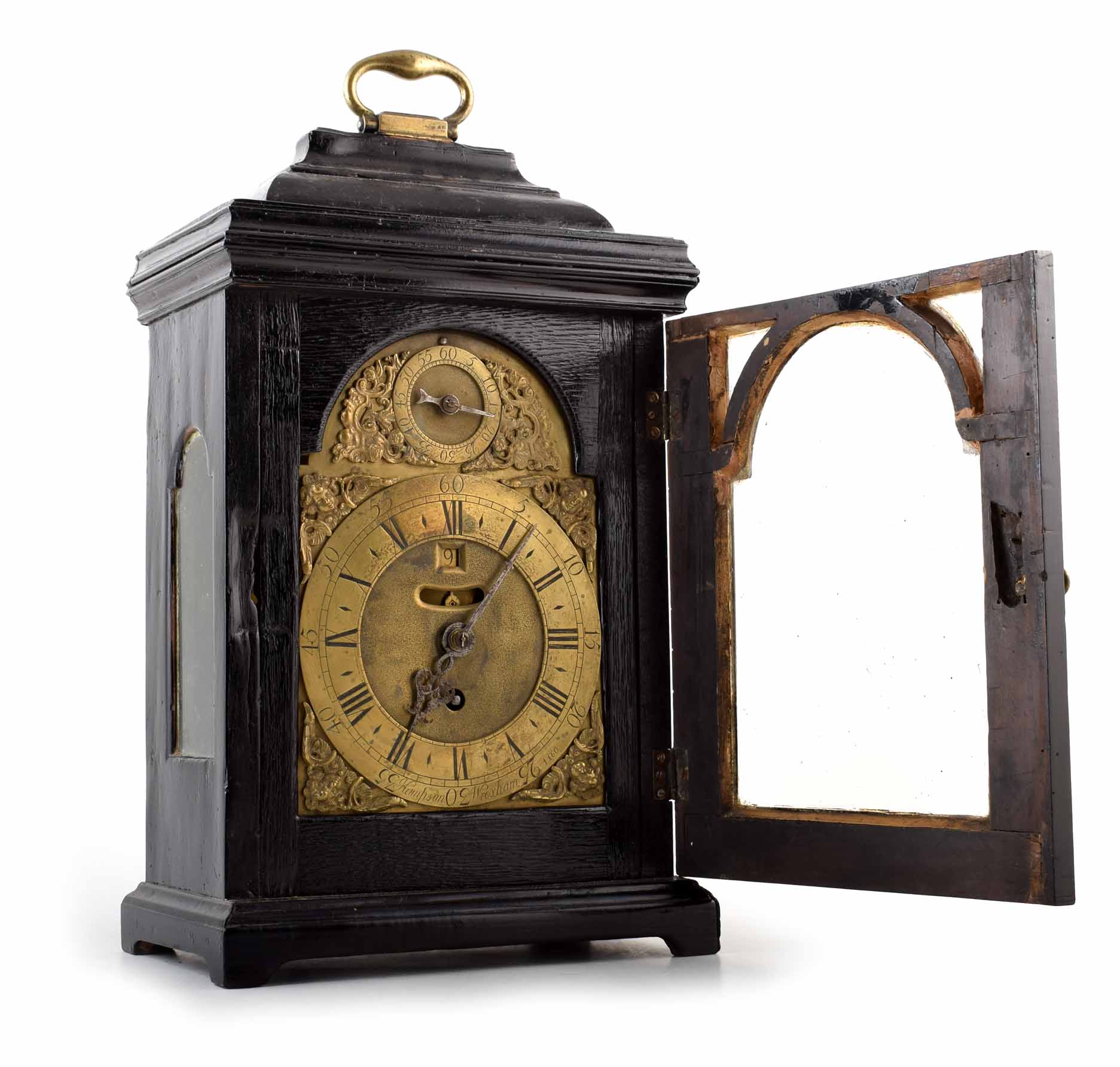 A mid 18th century ebonized bracket clock. Brass face with brass spandrels, Roman and Arabic chapter