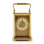 A 20th century carriage clock with brass case and enamel chapter ring with Arabic numerals. Swiss-