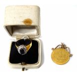 A sapphire and diamond ring and a middle eastern gold coin pendent No condition reports for this