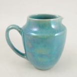A Ruskin pottery jug, decorated with a light blue lustre glaze, height 4.