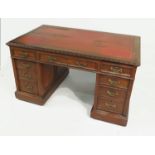 A rectangular mahogany desk, fitted with three frieze and three dummy drawers,