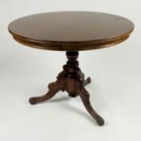 A 19th century rosewood circular tripod table, with quarter veneered top,