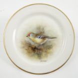 A Royal Worcester dish, hand painted with a Goldcrest by P M Platt, dated 1954, diameter 3.