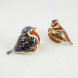 Two Royal Crown Derby paperweights, modelled as birds, decorate din the Imari pattern,