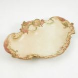 A 19th century Royal Worcester blush ivory dish, the shaped edge embossed with shells and scrolls,