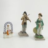 A late 18th/ early 19th century English porcelain figure, of a lady holding a bow,