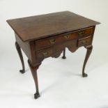 An 18th century oak lowboy,