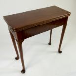 A Georgian style mahogany slender games table, with fold over top fitted with an end drawer,