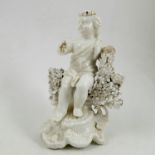A Stevenson and Hancock Derby figure, in white glaze, of a seated figure with flower garland,