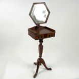 An Edwardian mahogany shaving stand, with hexagonal mirror fitted with two drawers to the stand,