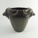 An Ashtead Potters vase, modelled with a pair of Buffalo head handles, attributed to David Furse,