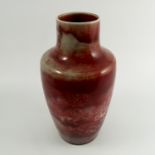 A Ruskin Pottery vase, of high waisted form, decorated in a red and white lustre glaze, height 10.