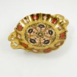 A Royal Crown Derby dish, decorated in the 1128 Imari pattern, raised on a circular foot,