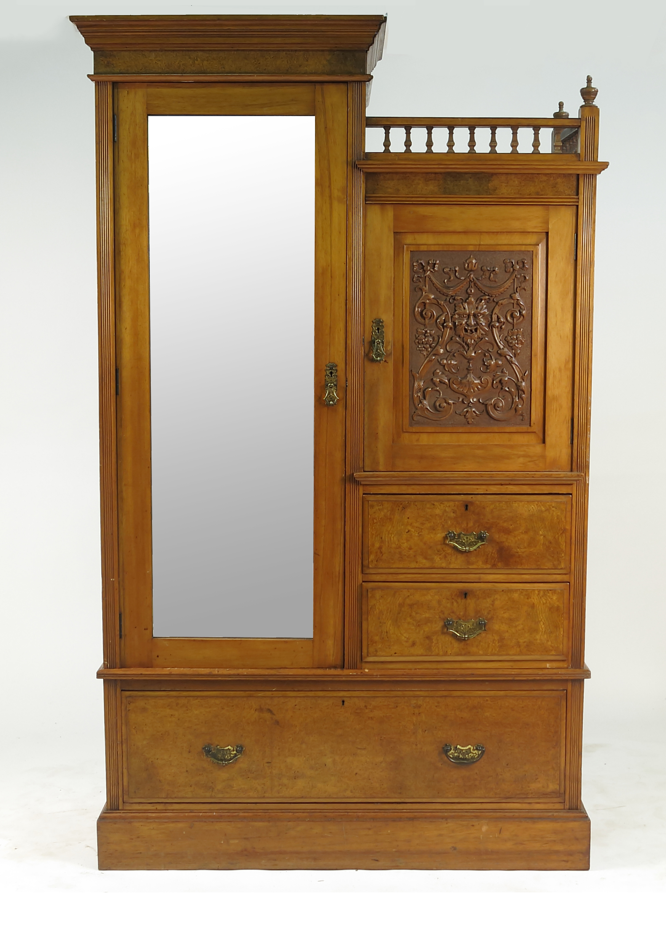 An Edwardian satin walnut wardrobe, with mirror door flanked by a carved door,